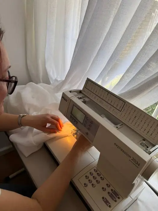 Curtain hem being professionally sewn during an Adelaide installation