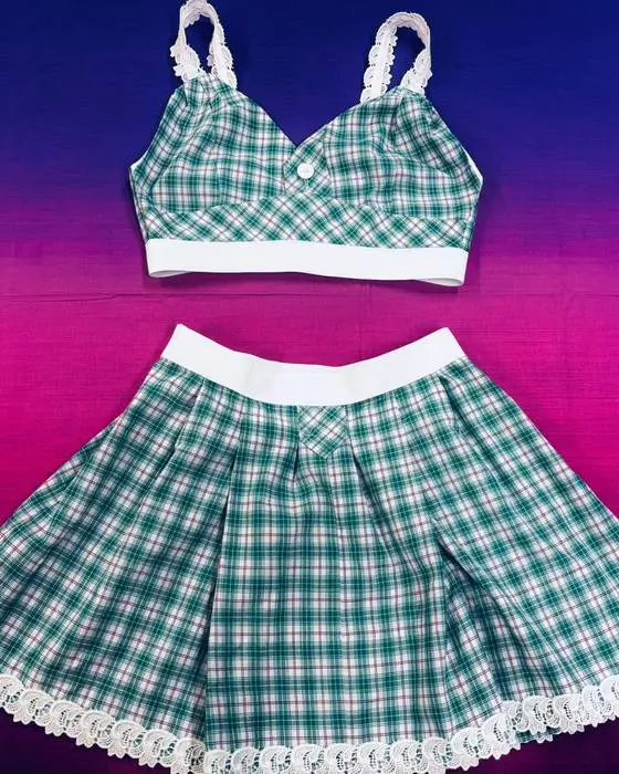 Green checked school uniform transformed into a lace-trimmed top and pleated skirt