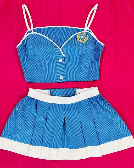 Blue school uniform transformed into a fitted Schoolies top and pleated skirt